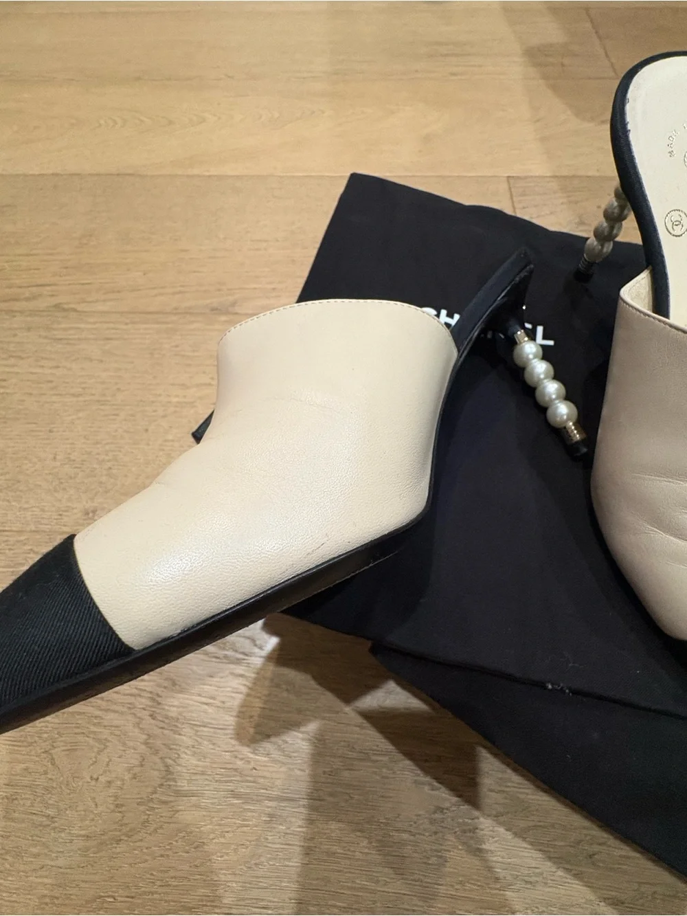 CHANEL Two-Tone Leather Mules with Pearl-Embellished Heel in White & Black